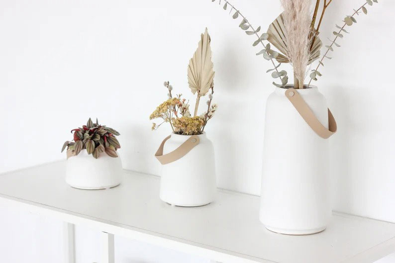 three-white-vases-on-table